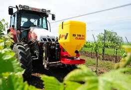 [Translate to APV RU:] Einscheibenstreuer ES 100 M1 Classic an der Front des Traktors im Weingarten 